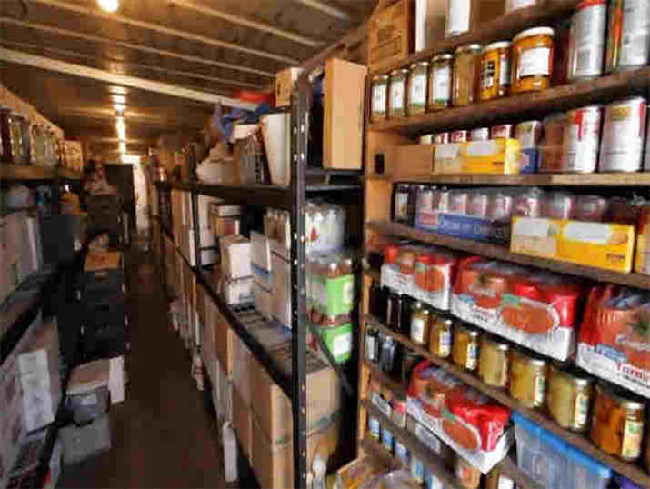 Shelves of jars and canned food in a working pantry